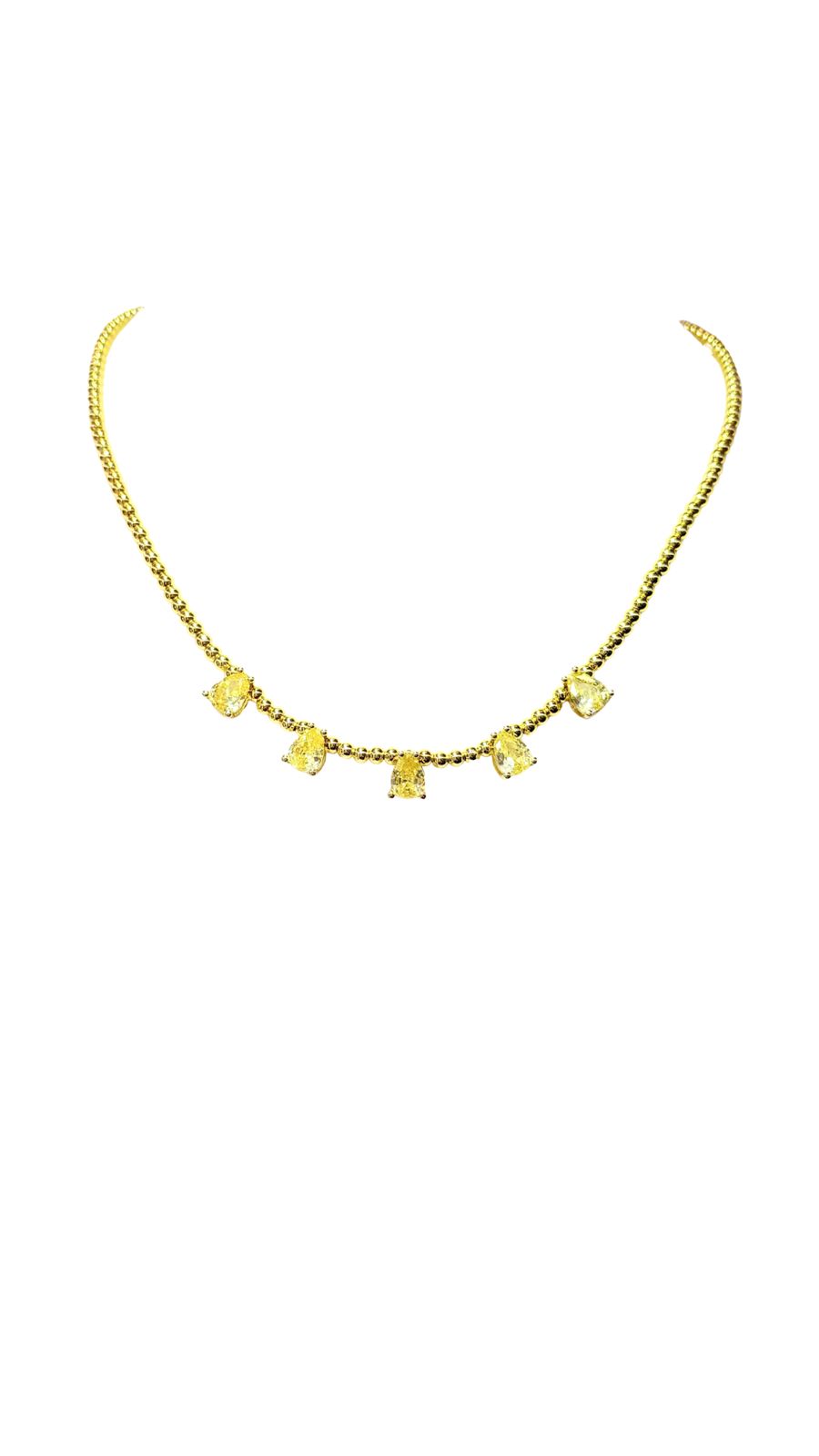 Collar dorado y gotas amarillas